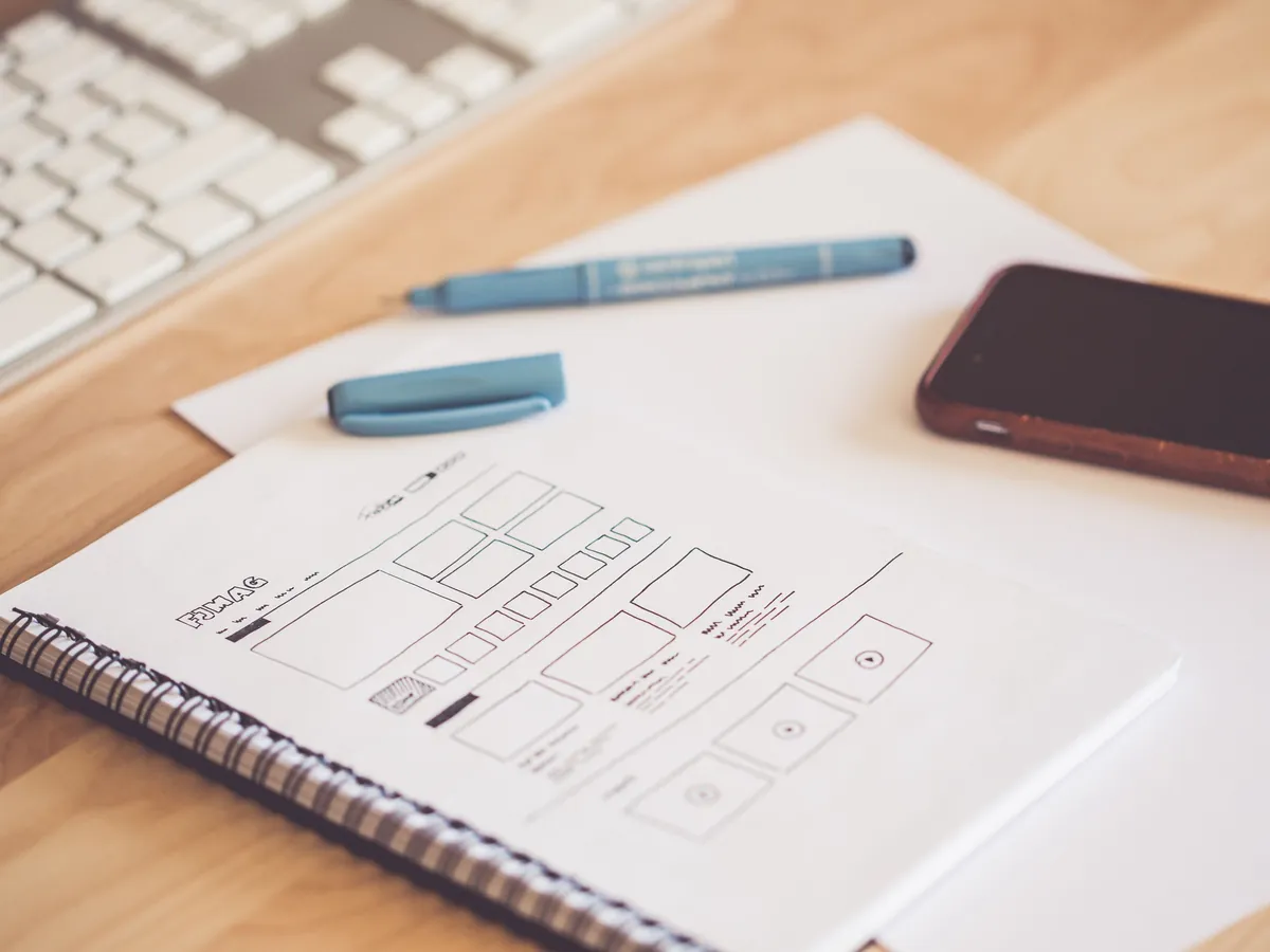 Website redesign wireframe sketched in a notebook